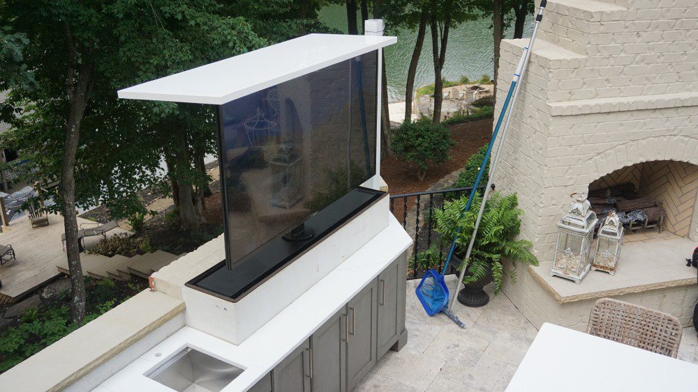 Auton concealed television lift at impressive outdoor entertainment area and living space