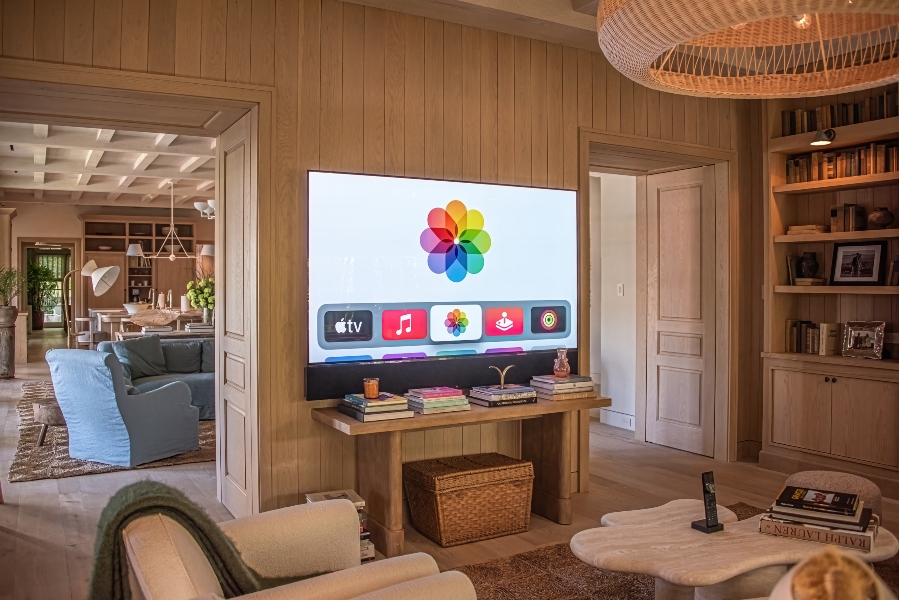Cabana-style living room with live wood paneling and Sony flat-screen TV with Sonos soundbar